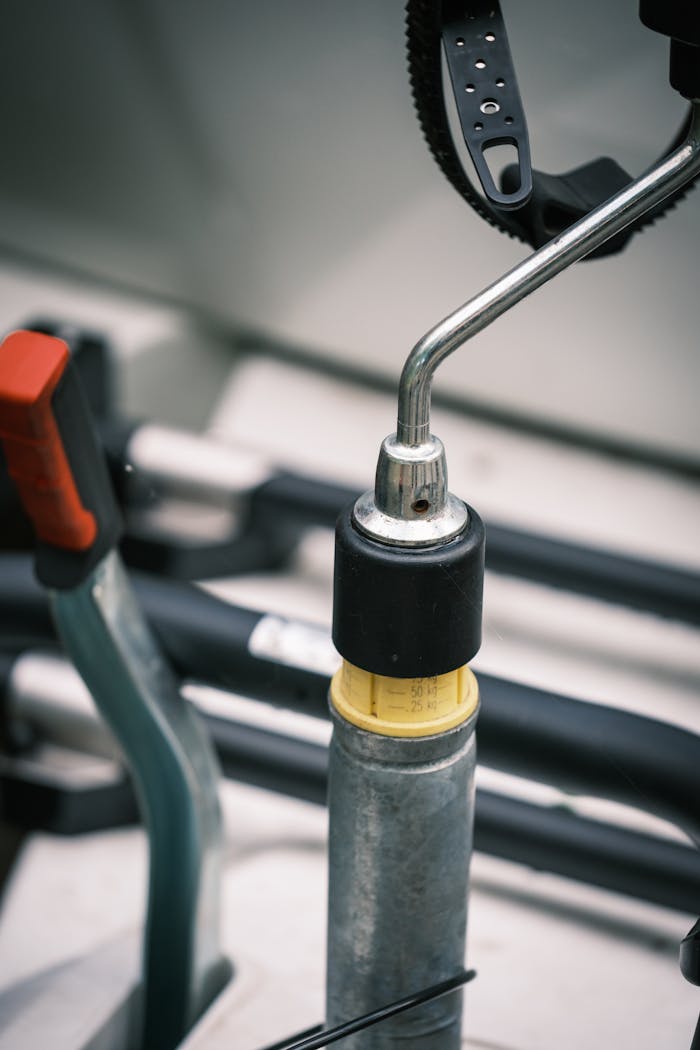 Detailed view of metal levers and handles inside a camper van, focusing on mechanical parts.